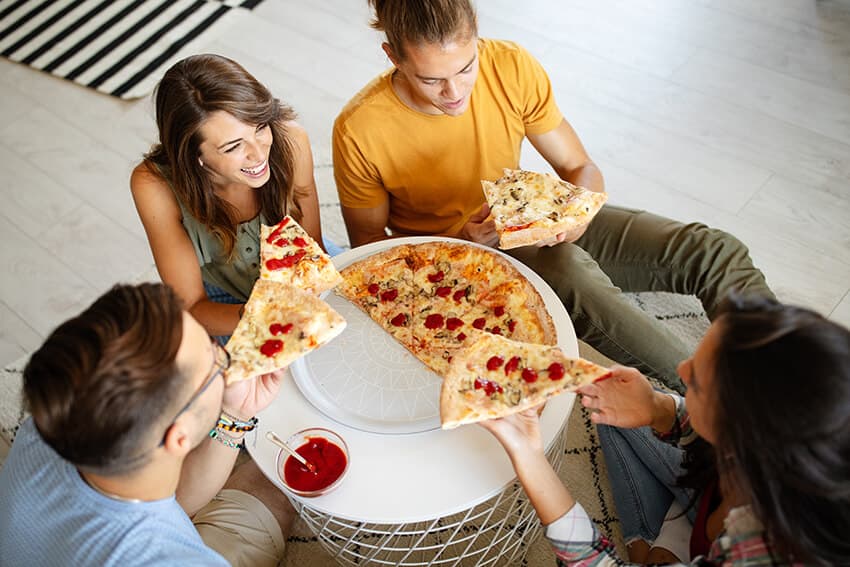 cheerful-group-of-friends-having-fun-at-home-eatin-XX7EJBK.jpg