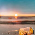 clear glass mason jar on beach during sunset